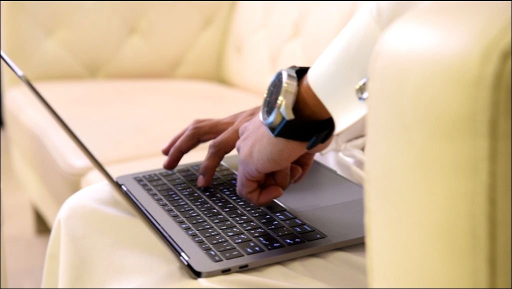 Arabic man working on laptop and mobile