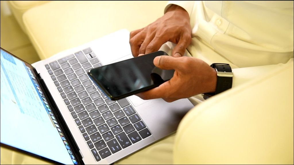Arabic man working on laptop and mobile